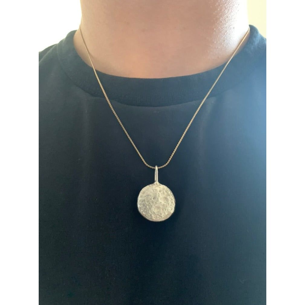 Backside image of half ounce pendant being worn