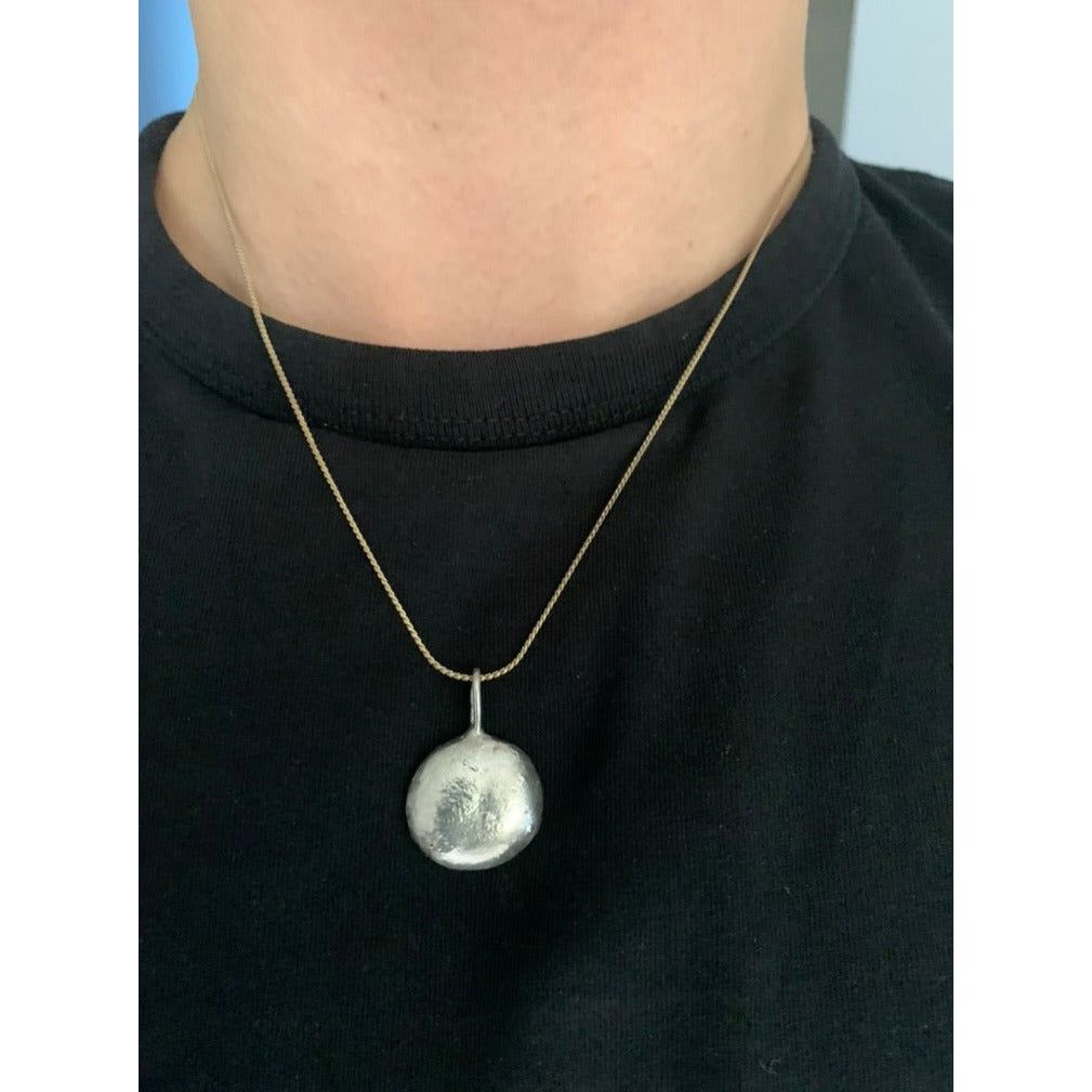 Frontside image of half ounce pendant being worn