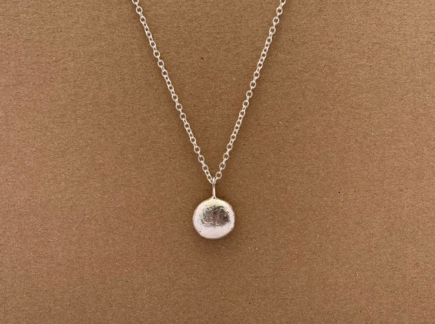 Frontside image of half ounce pendant on a chain 