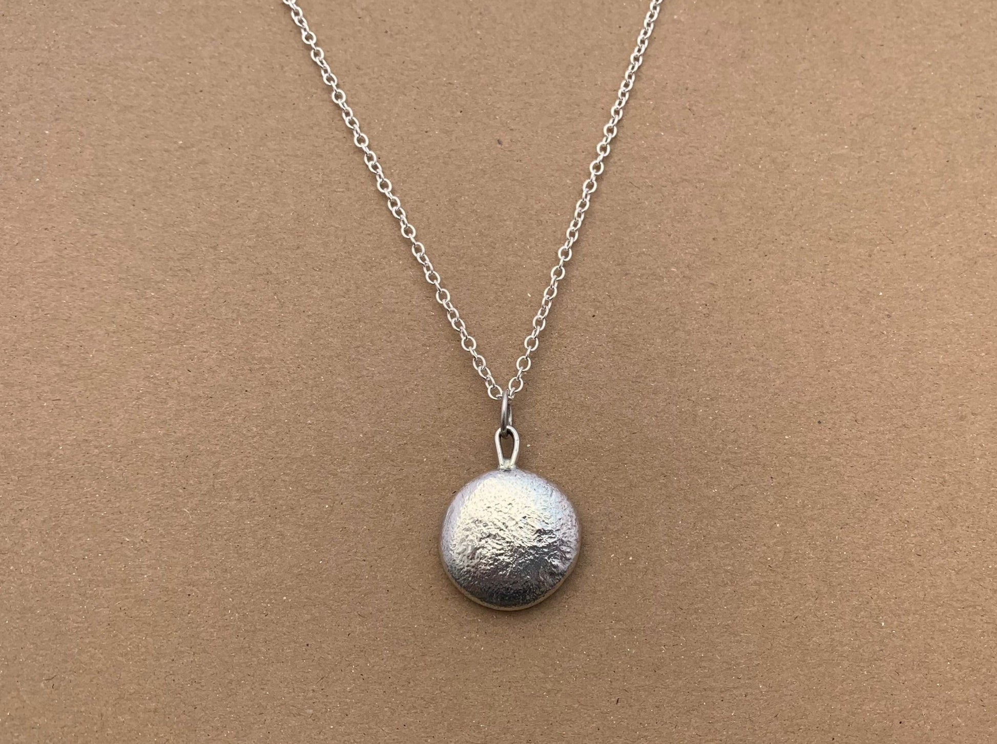 Frontside image of a one ounce silver pendant on a chain