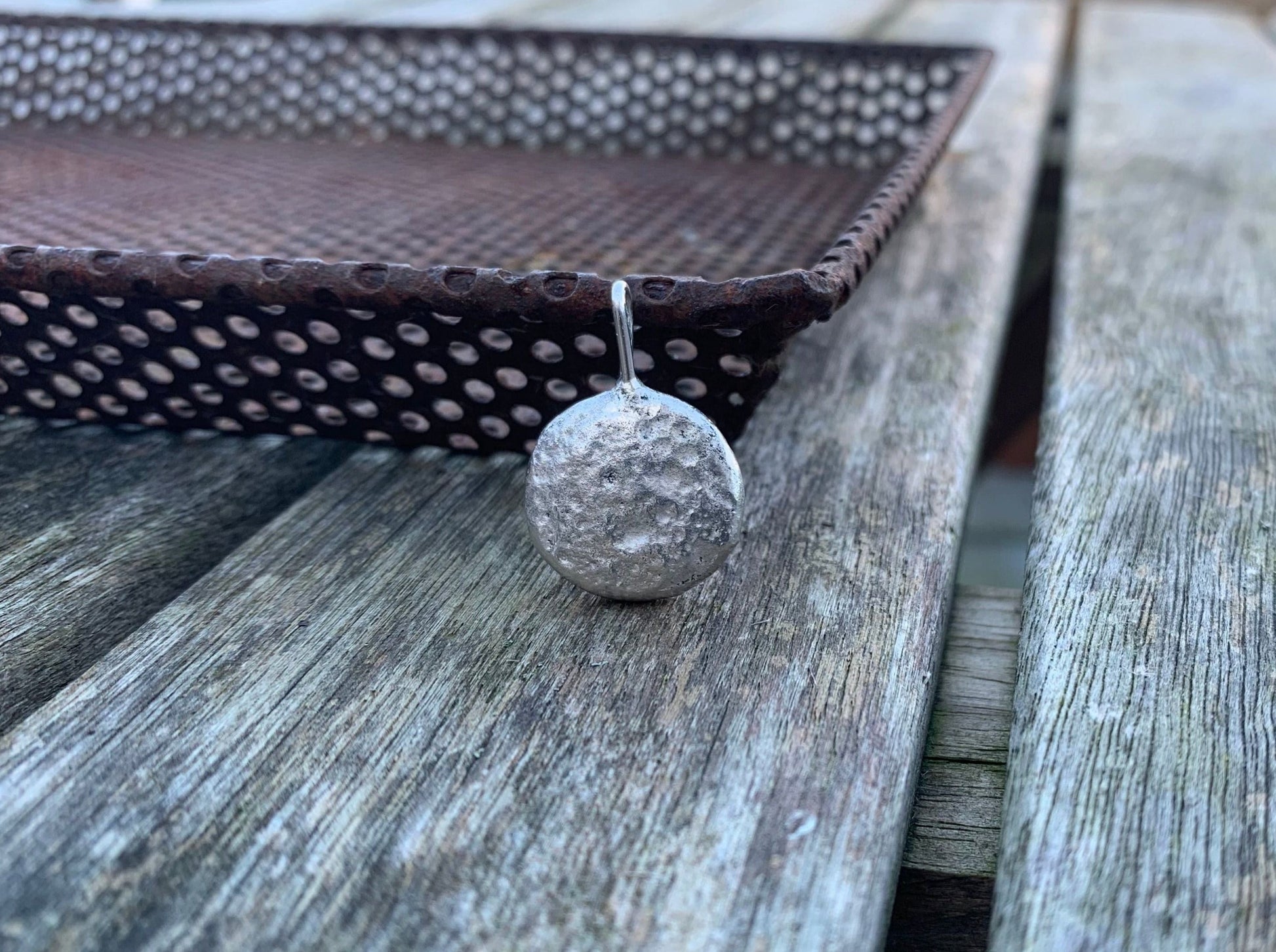 Backside image of half ounce pendant  on a metal tray 